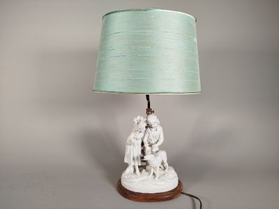 a lamp that is sitting on a table with a green shade