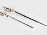 two swords, one with a gold handle and one with a black handle