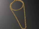 a gold necklace with a chain that is attached to it