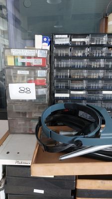 a table with a bunch of boxes and a pair of scissors on it