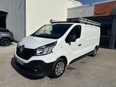 une camionnette blanche garée devant un bâtiment dans un parking