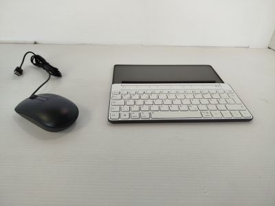 a laptop and a mouse on a white table