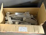 a cardboard box with a bunch of metal parts in it