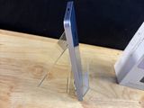 two cell phones sitting on a table next to each other