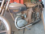 an old motorcycle that is parked in a garage