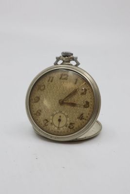 an old pocket watch sitting on top of a white surface