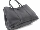 black leather handbag on white background with clipping for text