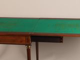 an old wooden desk with a green top and metal legs