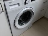 a washing machine in the corner of a kitchen