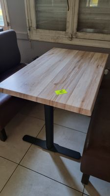 a table and two chairs in the corner of a room