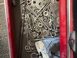 a red box with a bunch of screws and nuts in it