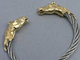 a close up of a bracelet with a horse head on it