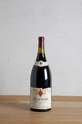 a bottle of wine sitting on a wooden table