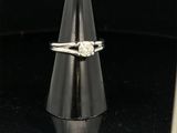 a close up of a diamond ring on a cone on a black surface