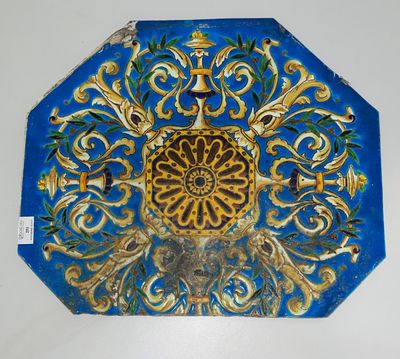 a blue and gold plate with a flower design on it