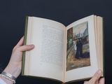 a person holding an open book with a picture on it