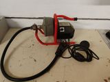 a picture of a red and black pump on a counter