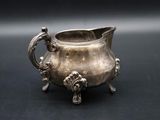 an antique silver plated bowl with handles and handles on a black surface