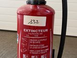 un extincteur rouge muni d'un tuyau
