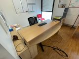 a desk with a laptop on it in a room