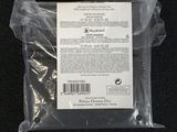 a plastic bag with a label on it on a black surface