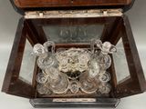 a glass case with a bunch of glasses inside of it