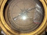 a gold clock that is sitting on top of a table