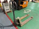 a fork lifter sitting on the floor in a warehouse