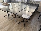 a table that has a bunch of chairs around it