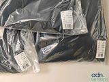 a pile of black clothing wrapped in plastic on a table