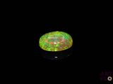 a close up of a green and red fire oplite on a black background
