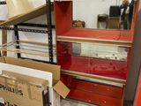 a red cabinet and a shelf in a room
