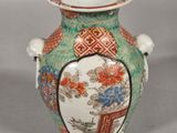 a vase with a lid that has a design on it
