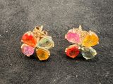 pair of multicolored flower earrings on a black surface