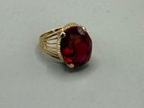 an image of a ring with a red stone in it