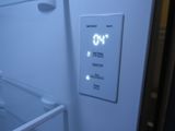 a clock on the side of a refrigerator door