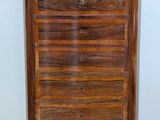 an image of a wooden chest of drawers on a tiled floor