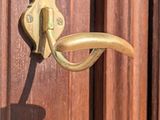 a close up of a door handle on a wooden door