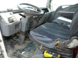 the interior of a truck with a steering wheel and a seat