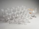 a lot of wine glasses that are lined up together