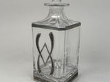 an image of a glass bottle with a metal handle