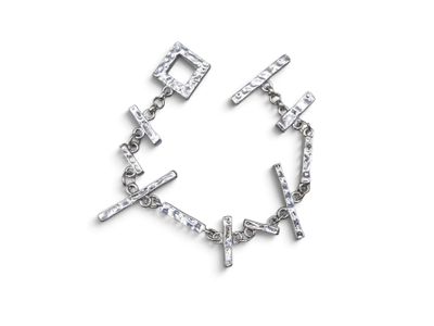 a close up of a bracelet with a cross on it