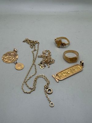 a lot of gold jewelry on a white table
