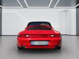 the rear end of a red sports car in a white room