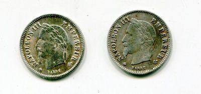 two silver coins with a woman ' s head and a man ' s head on them