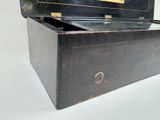 an old black box with a gold label on it