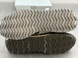 pair of shoes on top of a shoe box on a table
