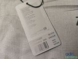 a tag on the back of a t - shirt that says black