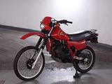 a red motorcycle that is parked in a parking garage