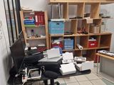 a desk with a computer and a monitor in a room
